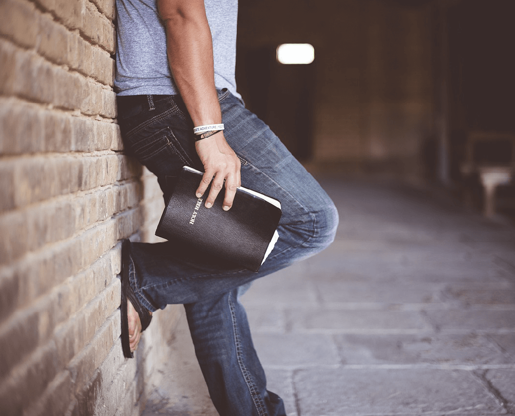 man-holding-bible Man holding Bible